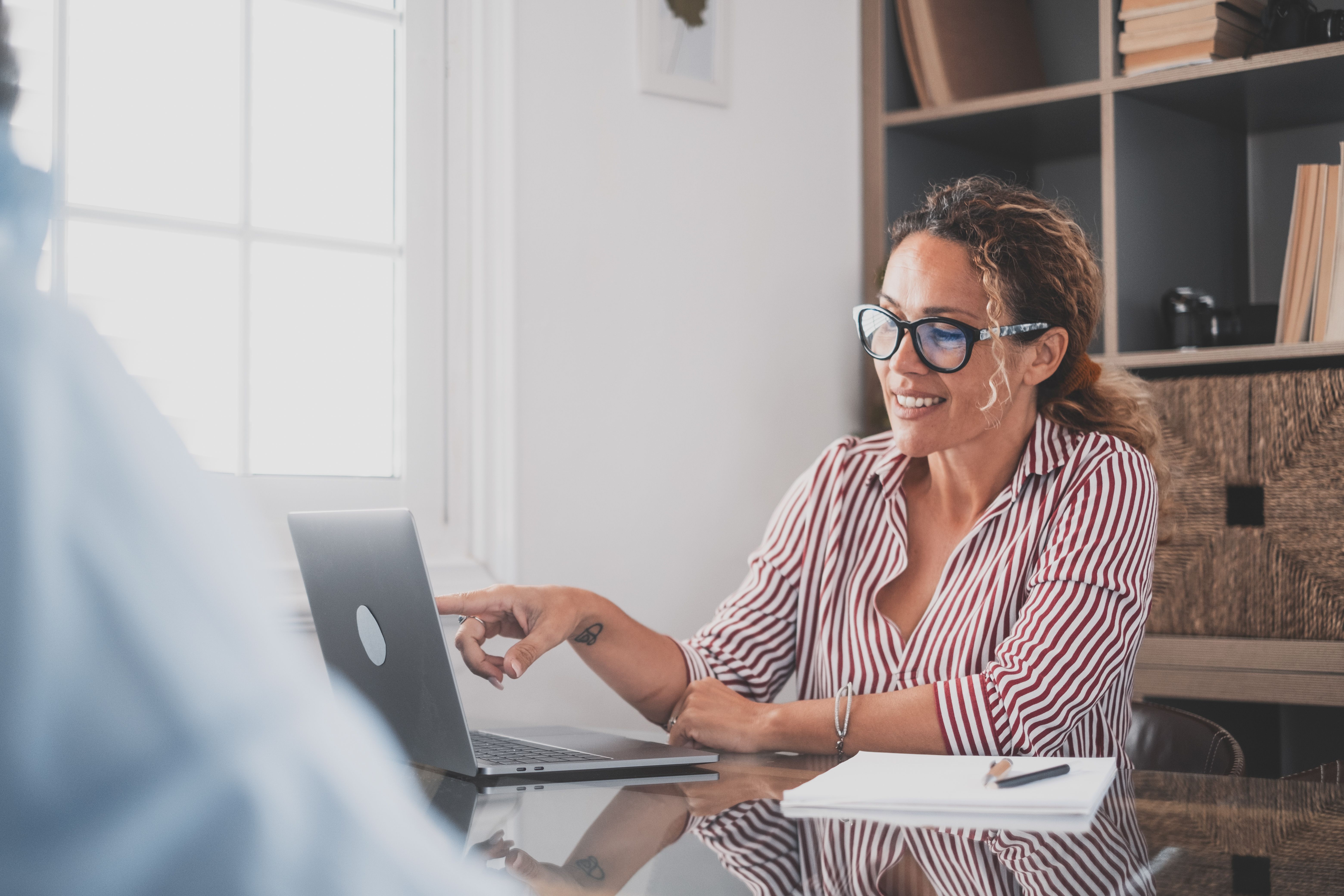 Portrait of beautiful woman smiling and talking to a man next to her talking about business